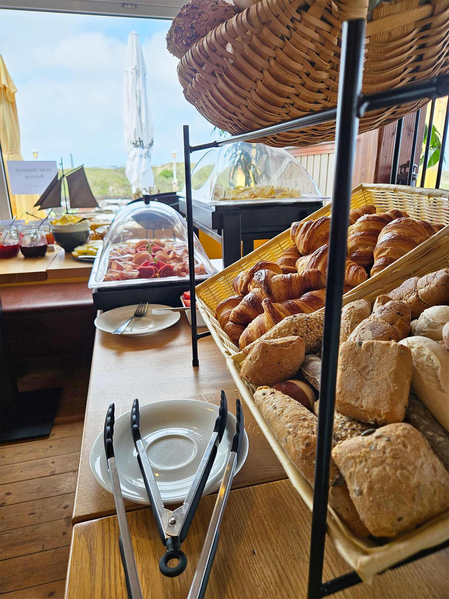 Ein reichhaltiges Frühstücksbuffet mit Brötchen und Croissants lädt im Strandcafé Sturmeck zum Genießen ein.